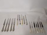 a lot of knives that are laying on a table