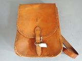 a brown leather bag with a white tag on it