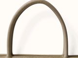 the small beige bag is sitting on a white surface