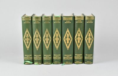 six green books are lined up in a row on a white surface