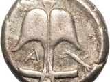 a silver coin with a tree on it on a white background