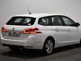 the rear end of a white car parked in a room