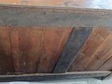 an old wooden chest with a metal handle on it