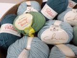 many balls of yarn in a basket on the table