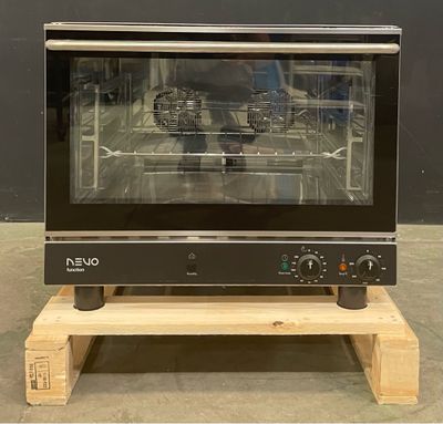 a black oven sitting on a wooden stand in a room