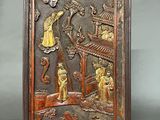 an image of a wooden plaque with a picture of people in a garden