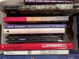 a lot of books that are stacked on top of each other