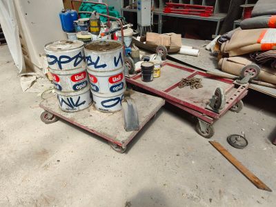 several cans of paint are sitting on a cart in a garage