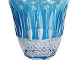a blue glass vase with a clear base on a white background