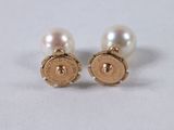 two pairs of pearl and gold earrings on a white surface