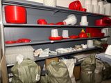 many red and white pots and pans on the shelves