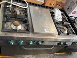 a silver stove top with four burners on it