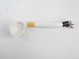 a white spoon with a black handle on a white surface