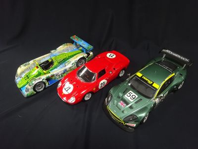 three toy cars sitting next to each other on a black surface