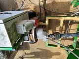 a green machine that is sitting on the side of the road