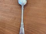 a spoon that is sitting on a wooden table