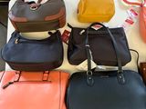 a lot of purses that are on a table