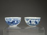 pair of blue and white bowls on a clear stand
