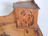 a small wooden clock on top of a wooden table