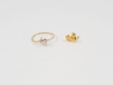 a pair of gold and diamond earrings on a white background