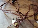 a wooden table with a bunch of wires and a cup of coffee on it