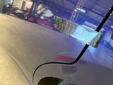 a close up of a blue car with a sticker on it
