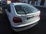 a white car that is parked on the side of the street