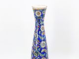 un vase bleu orné d'un motif floral
