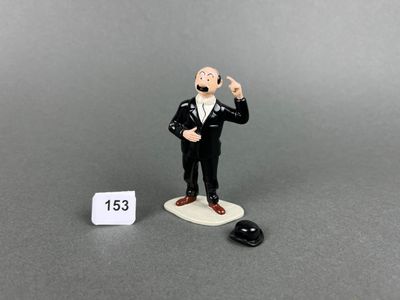 a figurine of a man in a tuxedo and a mouse