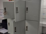 three metal lockers stacked on top of each other in a room