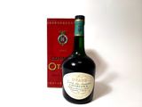 a bottle of wine sitting next to a box of wine