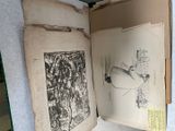 an open book with drawings on it sitting on a table