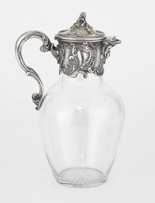 an antique silver plated glass pitcher on a white background