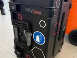 a black suitcase with stickers on it sitting on the floor