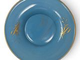 blue and gold plate with bamboo design on it