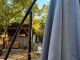 a blue umbrella that is outside in the sun
