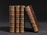 trois vieux livres sont empilés sur une table