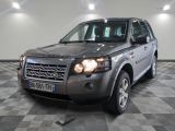 a picture of a silver land rover parked in a garage