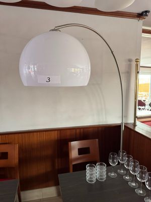 a table with wine glasses on it and a lamp above it