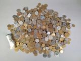 a pile of coins sitting on a table with a roll of paper