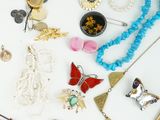 many different types of jewelry on a white surface