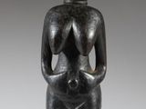 an image of a statue of a woman holding her hands on her chest