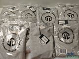 Plusieurs t-shirts sont emballés dans des sacs en plastique sur une table