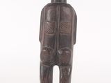 a wooden statue of a man with a hat on his head
