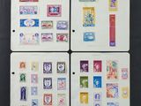 four different types of postage stamps on a black surface