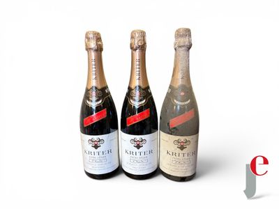 three bottles of champagne sitting next to each other on a white surface