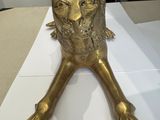 a gold statue of a lion sitting on a table