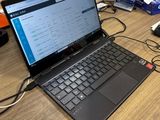 a laptop that is sitting on a desk with a keyboard