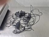 a lot of wires that are tangled up on the floor