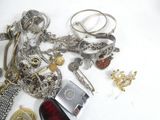 a lot of jewelry that is laying out on the table